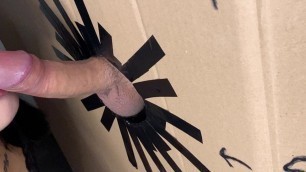 A hole in the wall with a cock and a girl sucking a cock